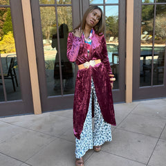 Rose blush velvet duster closed with tan belt with gold buckle and matched with leopard wide leg pants